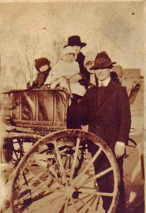 Becky and Louis Dumes, Hyman, Willie, and Jeannette behind Louis, before they owned a car.



 (~1918)