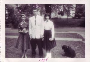 Karen Karp Finkelstein, John Karp, Beverly Karp Mahone dressed for High Holiday Services in Vincennes.  Dog is Chips.

 (1954)