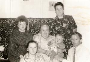 Traina (in the center) holding her great-granddaghter.  On the right is her daughter Raisa in front of Raisa, her husband Vasiliy.  On the left are their daughters Valentina (upper row) and Jelena. (1986)