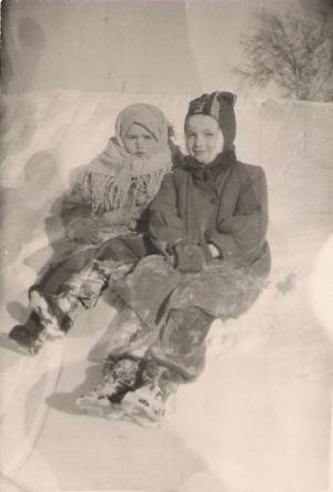 Julia (left) and Raisa.  Snowdrifts that winter were higher than the roofs of the houses. (1953)