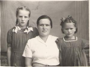 Tanya and her daughters Raisa (left) and Julia, dressed in clothes made by their mum. (1954)