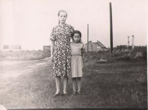 Tirgus Street, also known as Market Street, as there was a market there every Sunday.  The two columns on the right and the wall in the background are the remains of the synagogue of Vishki.  This is Raisa and Julia. (1957)