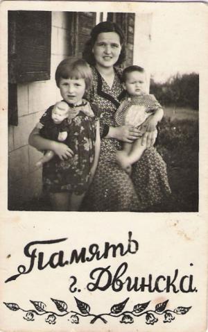 Traina Dumesh with her daughters Raisa (on the left with a doll) and Julia (on Traina's knee).  First days back in Vishki after her long wanderings.
 (1949)