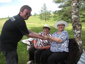 Bruce giving Julia some wild strawberries that he picked.   (2009)