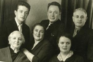 At the left: Boris Khitrin, grandson of Gescha Dumesh Khitrin, stands behind Gescha Dumesh Khitrin. The people in the center are unknown. On the right: Sema Khitrin, son of Gescha Dumesh, stands behind his wife, Sonya Khitrin.  

We had this dated originally as 1954, but Boris Khitrine wrote and said that it was taken in Summer 1962. (1962)
