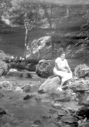 Freda Dumes, sitting on rocks
 